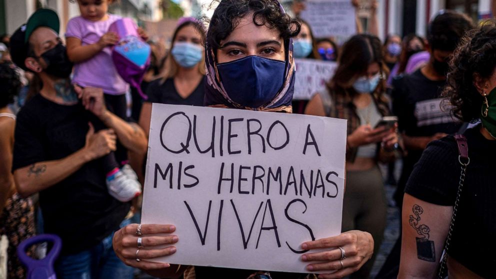 PHOTO: A woman member of a feminist collective holds a sign that reads in Spanish "I Want My Sisters Alive" during a demonstration against sexual violence in front of the governor's mansion in San Juan, Puerto Rico. May 3, 2021.
