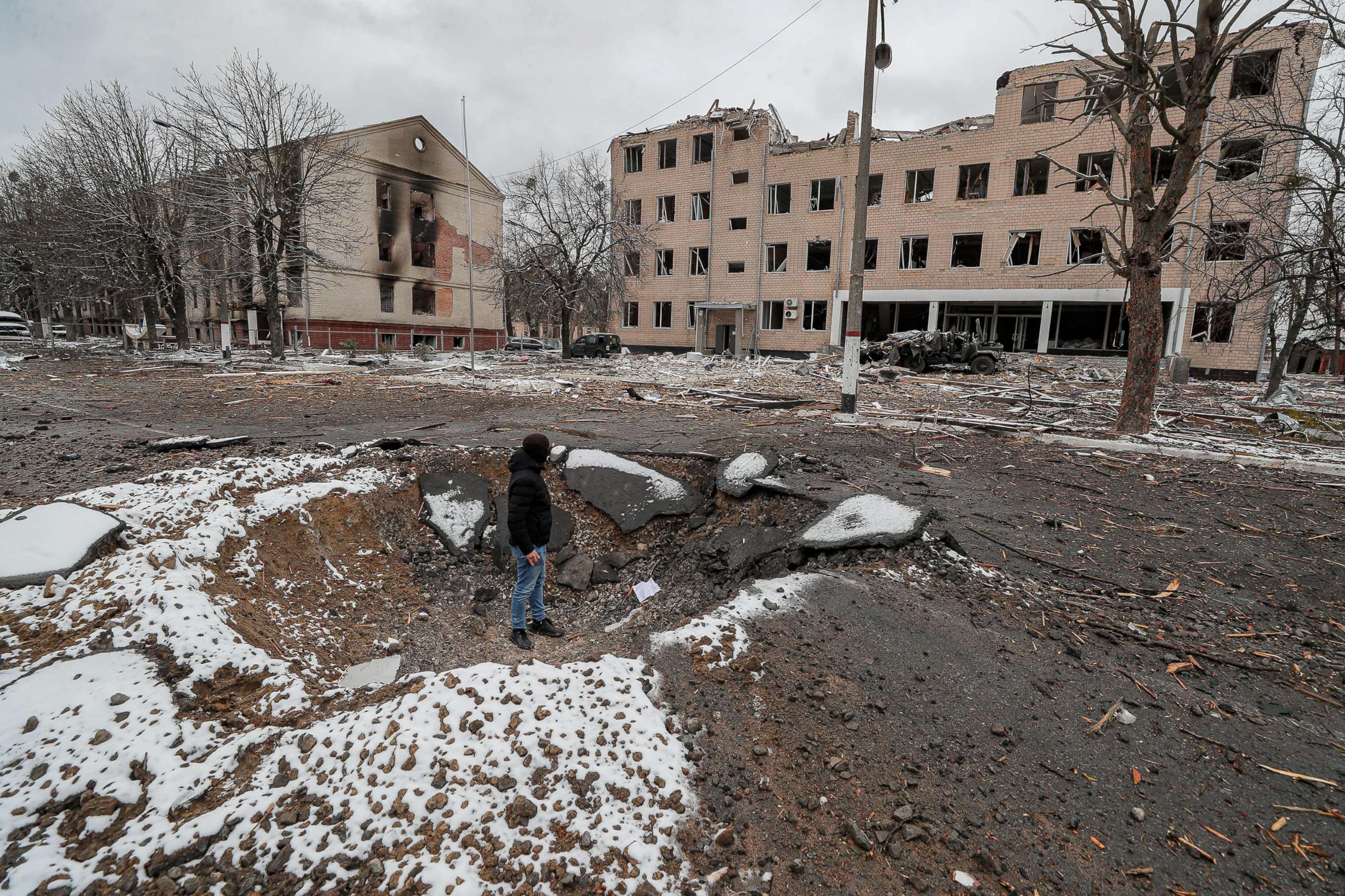 PHOTO: A man stands inside a crater in the aftermath of an overnight shelling on a military facility in Brovary near Kyiv, Ukraine, March 1, 2022.