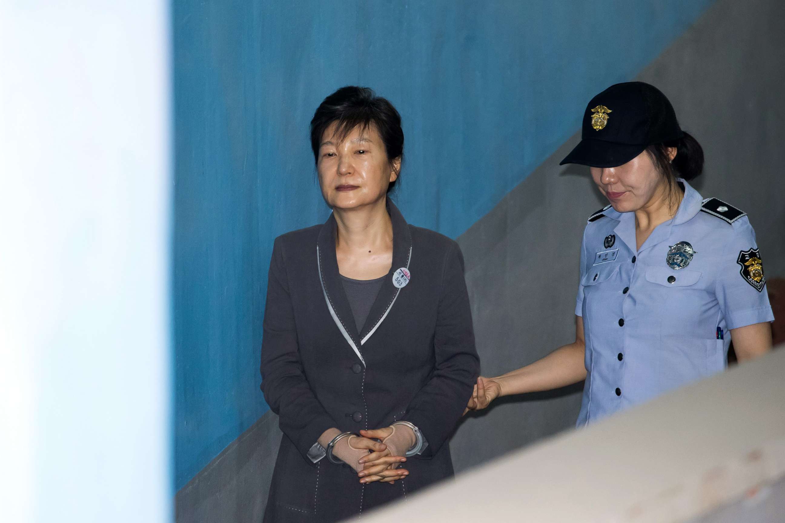 PHOTO: Park Geun-hye, former president of South Korea, is escorted by a prison officer as she arrives at the Seoul Central District Court in Seoul, South Korea, July 27, 2017. 