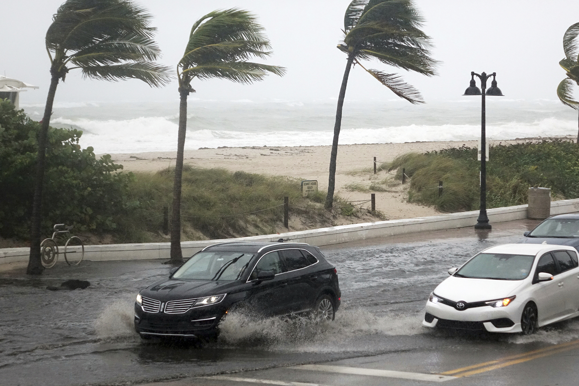 PHOTO: Cars move along flooded highway A1A  in Fort Lauderdale, Fla., Nov. 8, 2020.