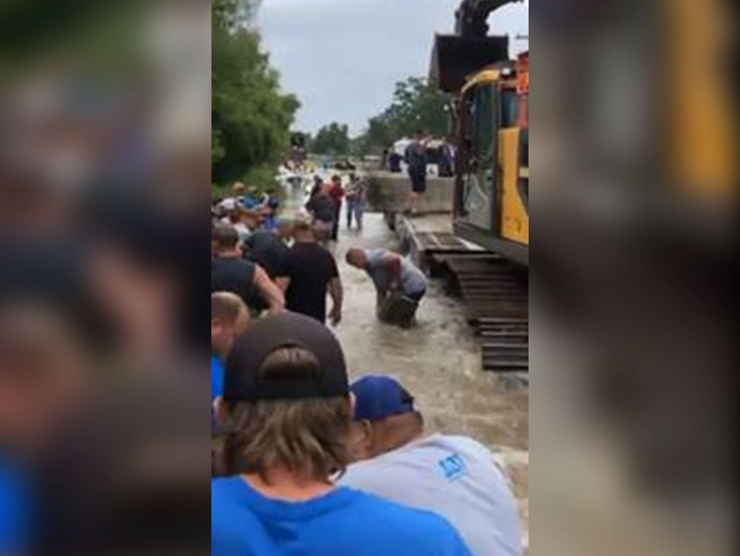 PHOTO: Volunteers try to get flooding under control after a temporary dam failure in Louisiana