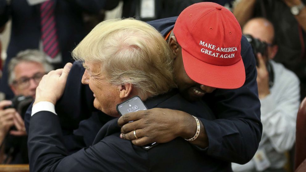 PHOTO: President Donald Trump hugs rapper Kanye West during a meeting in the Oval office of the White House, Oct. 11, 2018.