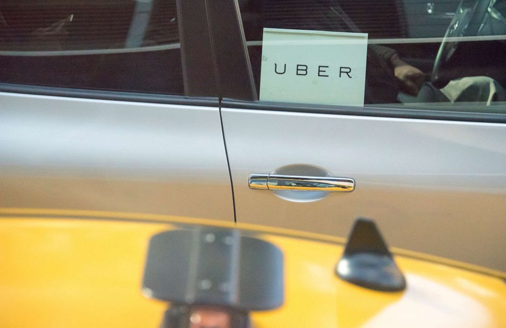 PHOTO: An UBER logo is seen in a car window. 