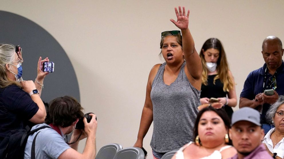 PHOTO: Tina Quintanilla-Taylor raises her hand as she tries to ask a question of the Texas House investigative committee at a news conference after they released its full report on the shootings at Robb Elementary School, July 17, 2022, in Uvalde, Texas.