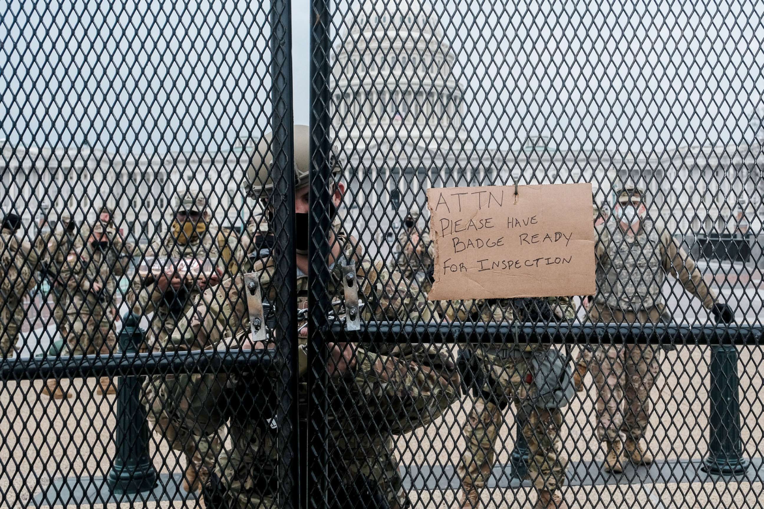 PHOTO: Member of the National Guard stand guard behind a security fence outside of the Capitol on Jan. 15, 2021.