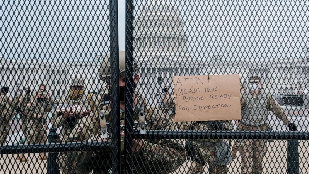 PHOTO: Member of the National Guard stand guard behind a security fence outside of the Capitol on Jan. 15, 2021.