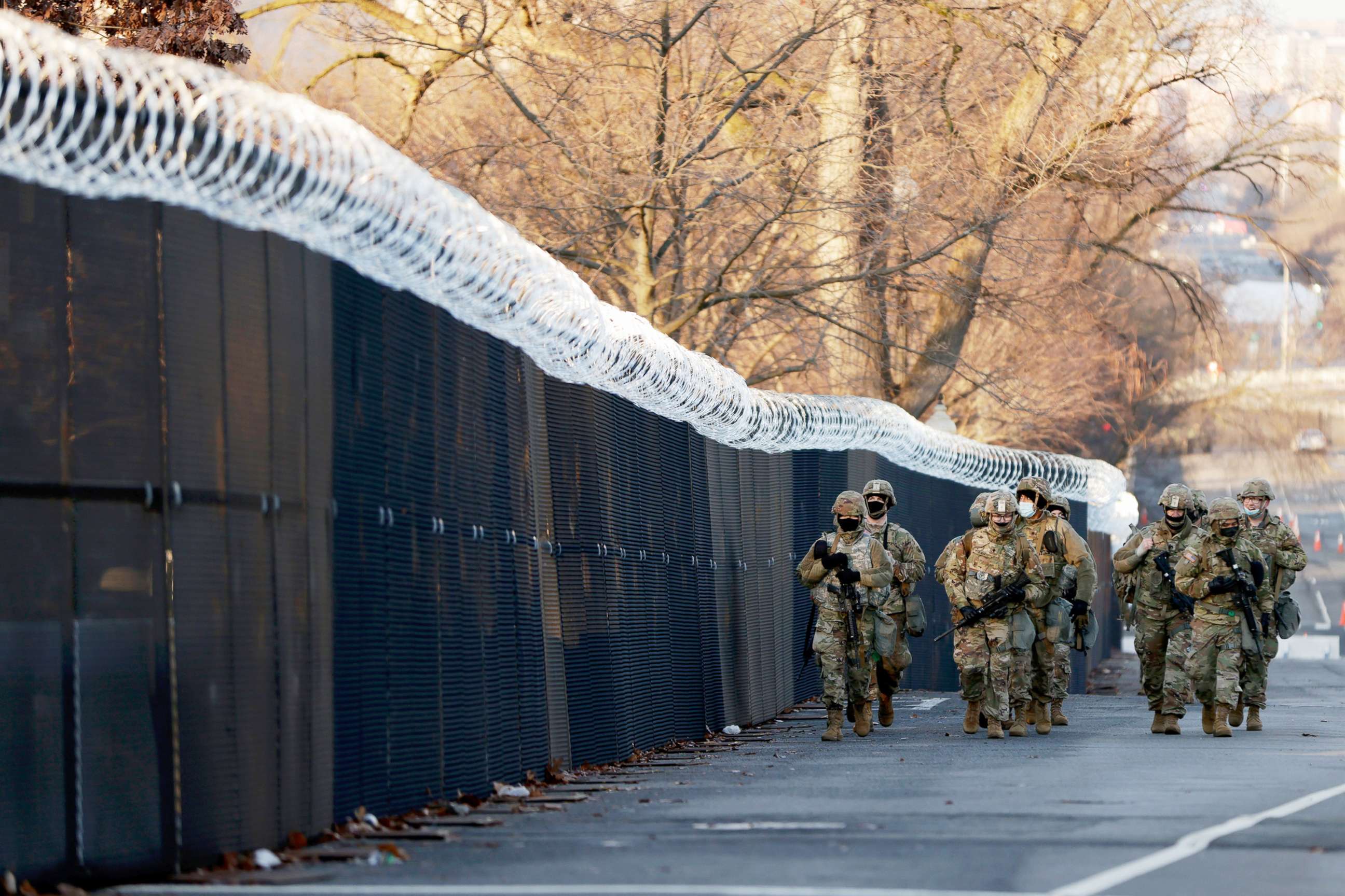 PHOTO: A group of Virginia National Guard patrol around the razor wire fence surrounding the U.S. Capitol grounds in Washington, Jan. 16, 2021. 