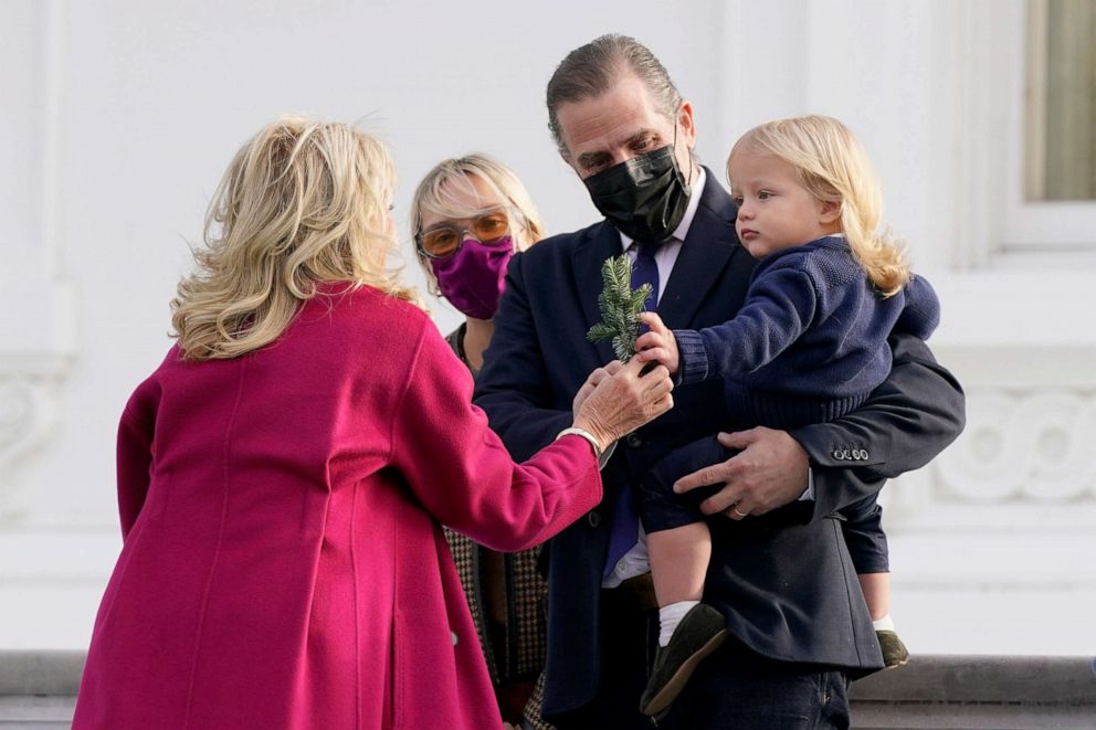 PHOTO: First lady Jill Biden hands a branch from the official 2021 White House Christmas Tree to Beau Biden, son of Hunter Biden, center, at the White House, Washington Nov, 22, 2021.