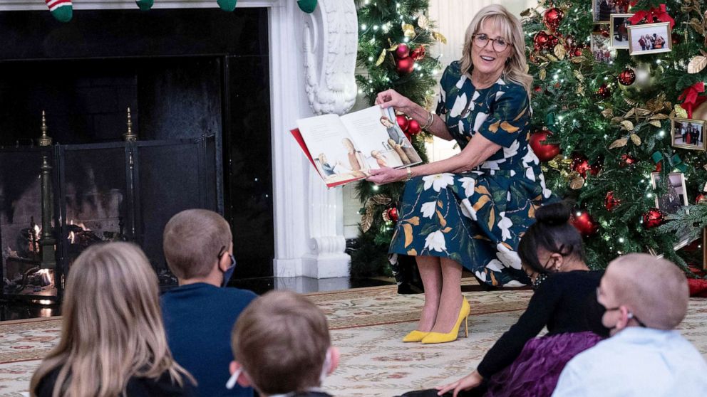 PHOTO: First Lady Jill Biden reads to students from Malcolm Elementary School, from Waldorf, Maryland, during an event in the State Dining Room at the White House, Nov. 29, 2021. 
