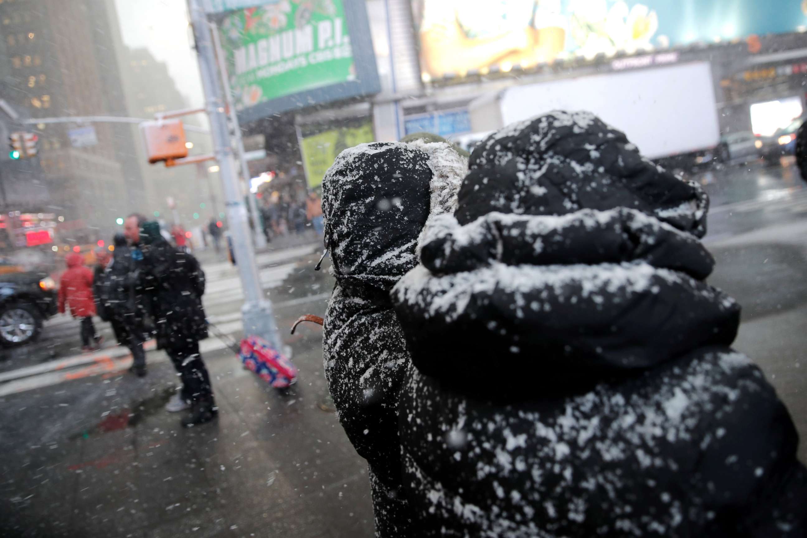 PHOTO: People walk through a snowstorm in Times Square in New York City, Nov. 15, 2018.