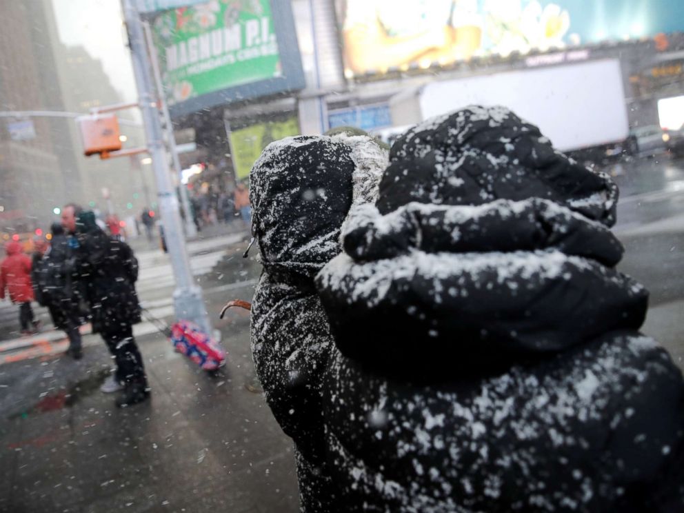 PHOTO: People walk through a snowstorm in Times Square in New York City, Nov. 15, 2018.