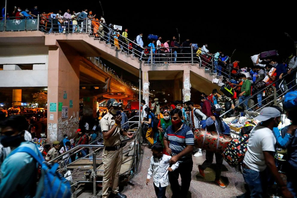 PHOTO: Migrant workers arrive at a bus station to board buses to return to their villages after the government ordered a six-day lockdown to limit the spread of COVID-19, in Ghaziabad on the outskirts of New Delhi, India, April 19, 2021.