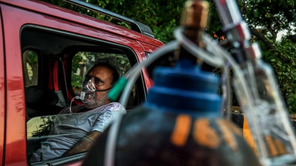 PHOTO: A man receives oxygen in a vehicle at a Sikh gurdwara (temple) in Delhi, April 25, 2021.