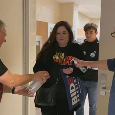 VIDEO: Volunteers offer hand sanitizer to attendees at Biden event