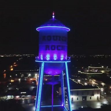 Texas water tower lit up for essential workers