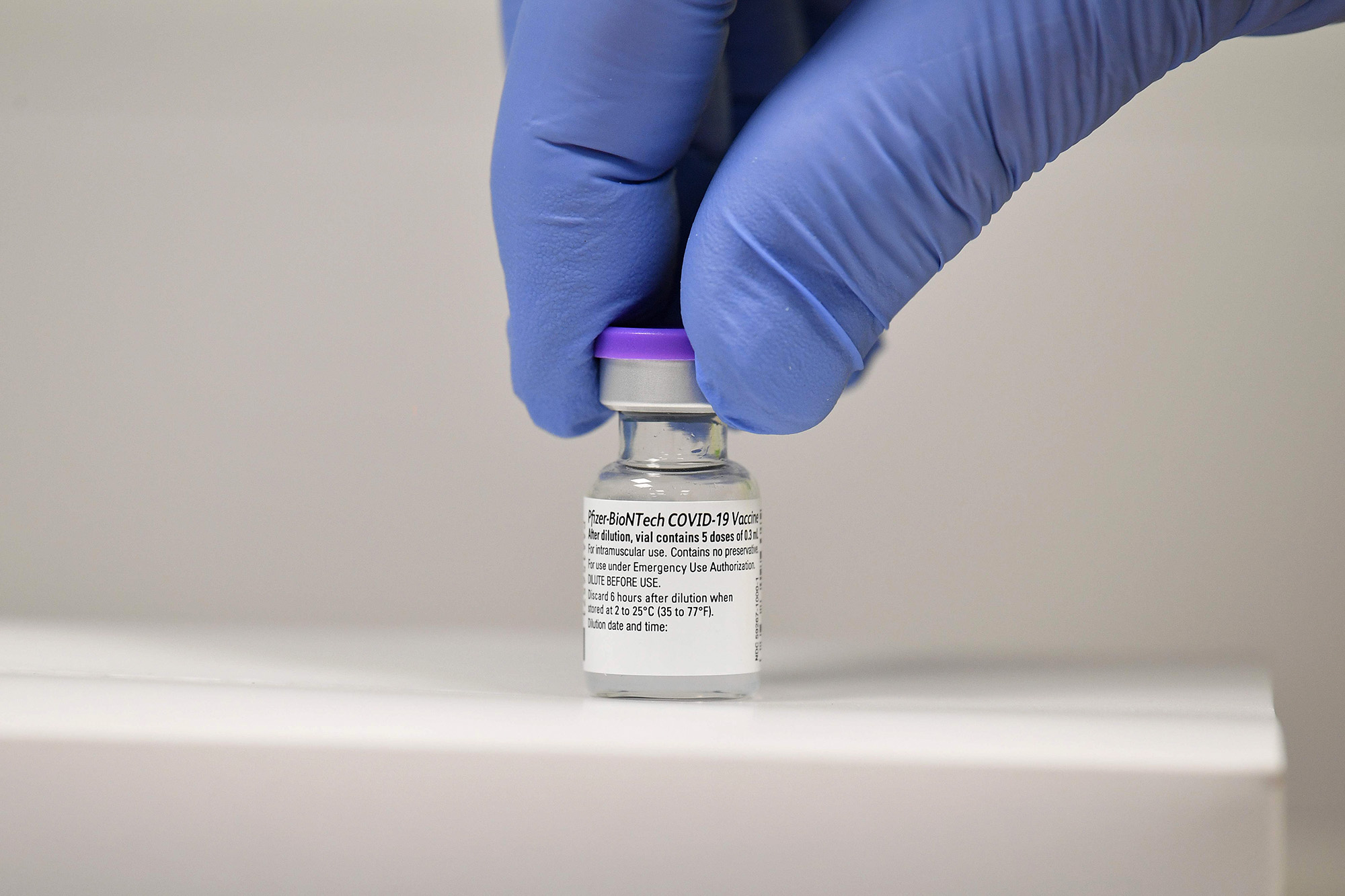 PHOTO: A member of staff adjusts a vial of Pfizer-BioNTech Covid-19 vaccine at a vaccination health centre in Cardiff, South Wales, Dec. 8, 2020.