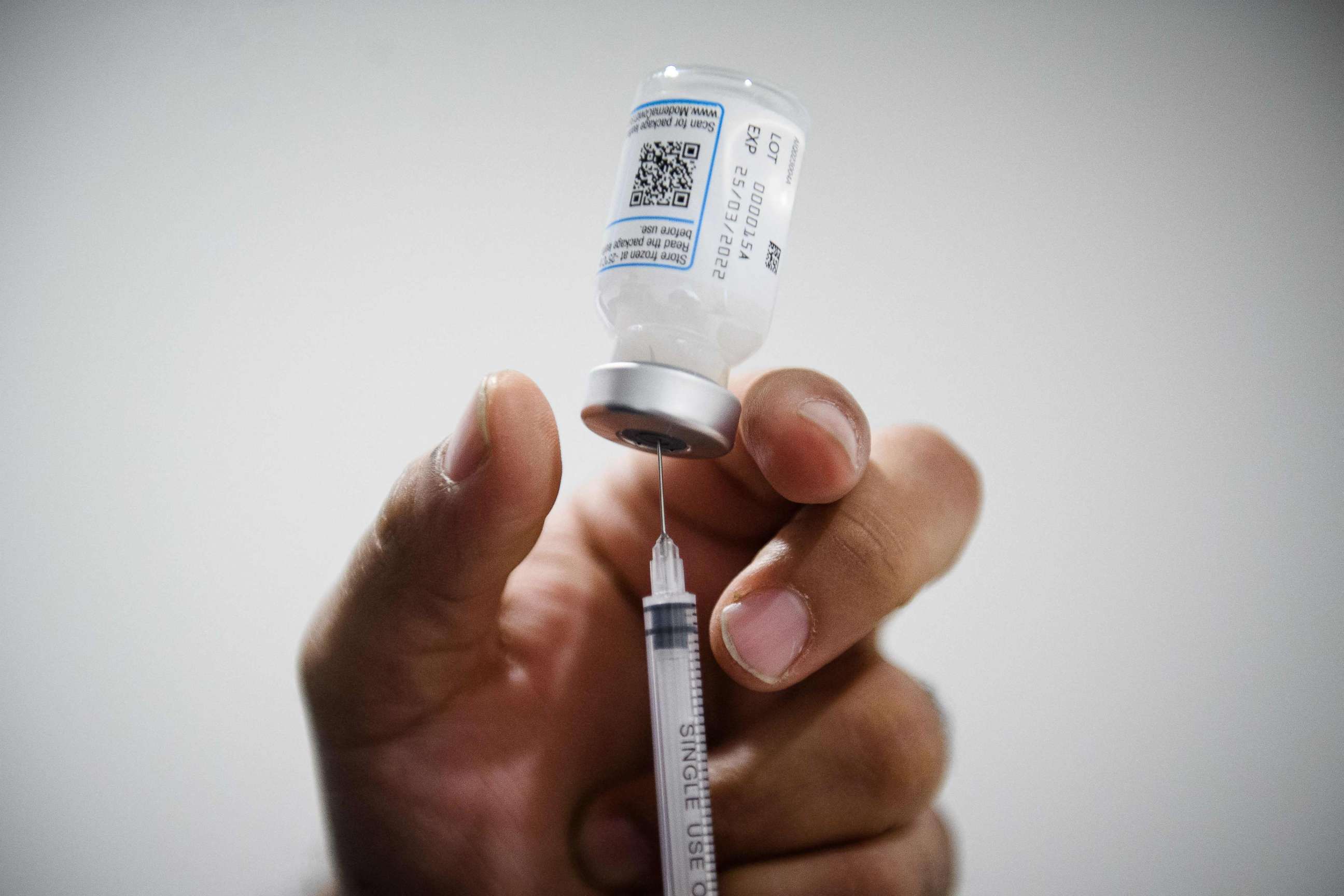 PHOTO: (FILES) In this file photo taken on January 12, 2022 a nurse prepares a dose of a Pfizer/BioNTech vaccine against the coronavirus disease Covid-19 in a social center of La Gavotte Peyret popular neighbourhood, in Septeme-Les-Vallons. 