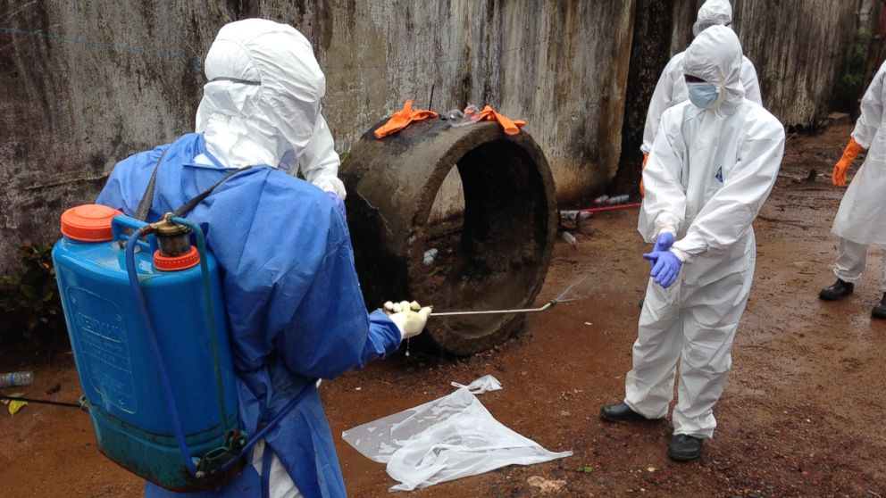 PHOTO: Ebola workers are pictured disinfecting in Liberia. 