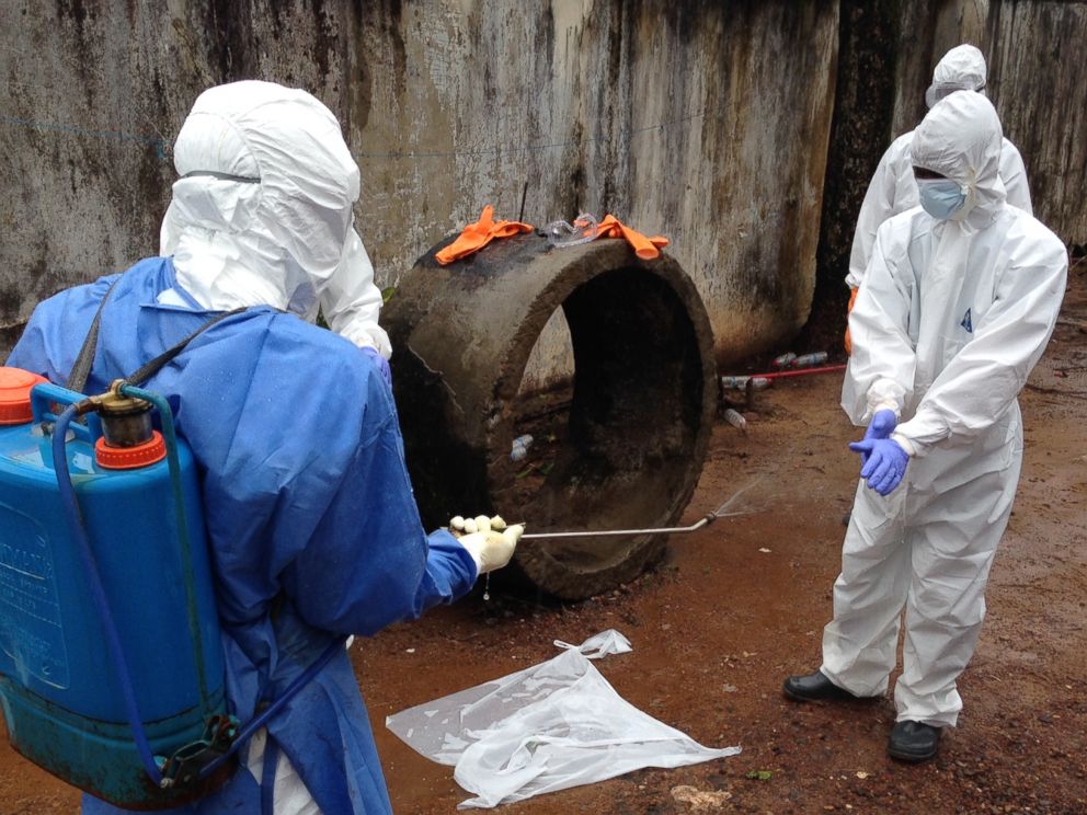 PHOTO: Ebola workers are pictured disinfecting in Liberia.