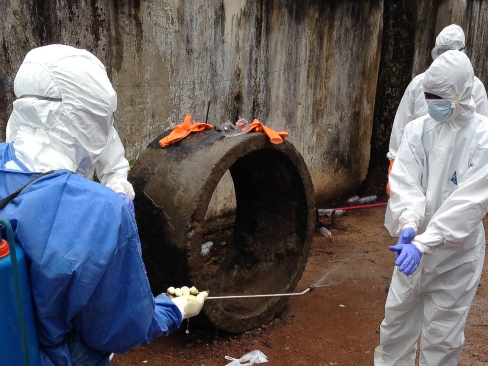 PHOTO: Ebola workers are pictured disinfecting in Liberia. 