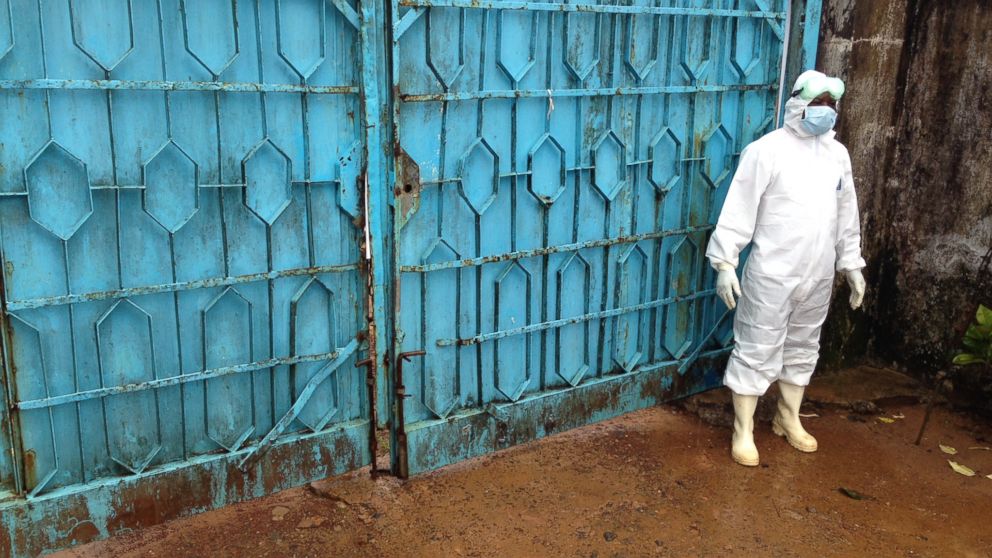 Blue gates guard the entrance to an Ebola treatment center in Monrovia, Liberia.
