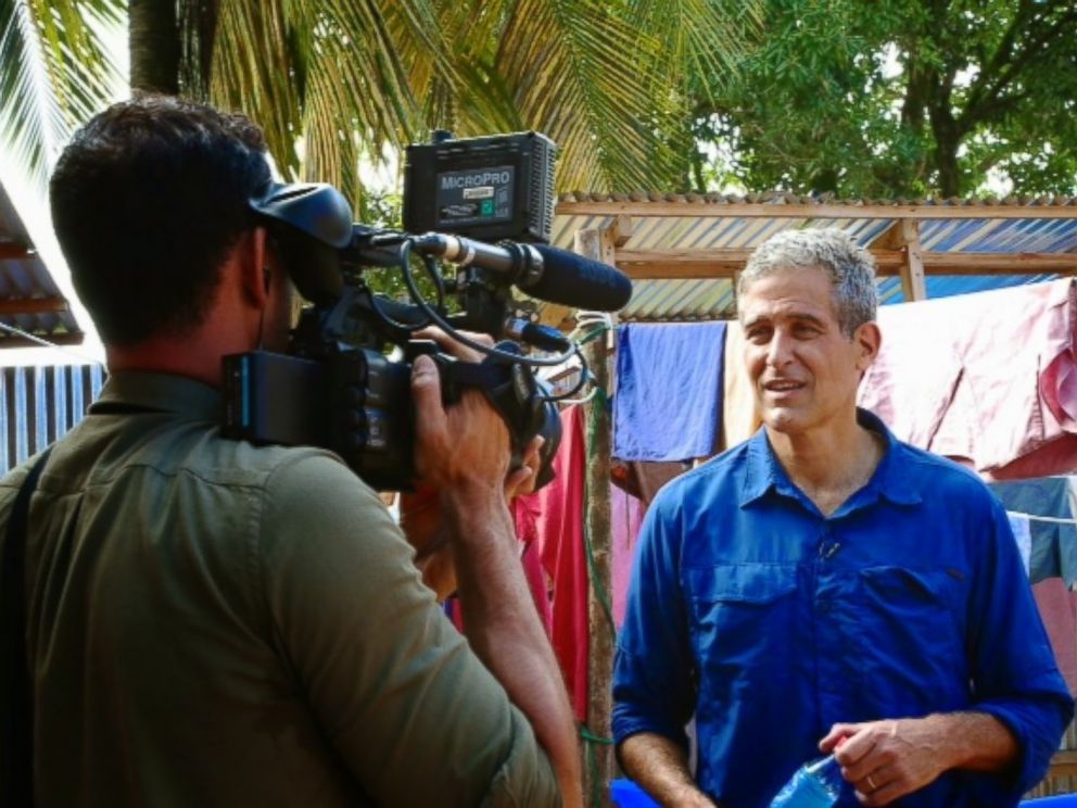 PHOTO: Dr. Besser stands in front of the camera outside the Ebola ward in Monrovia.