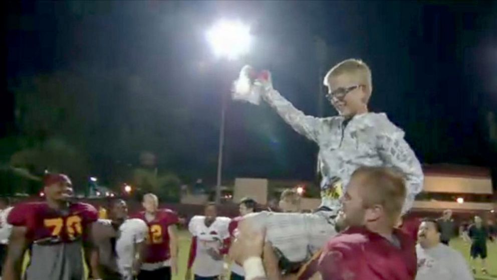 PHOTO: When Olson was 12 and lost his second eye to retinoblastoma, he met the USC Trojans in person and got to see the field one last time before becoming totally blind.
