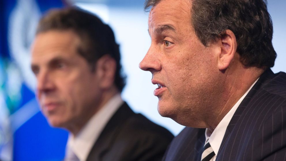 New York Governor Andrew Cuomo, left, listens as New Jersey Governor Chris Christie talks at a news conference, Oct. 24, 2014 in New York.