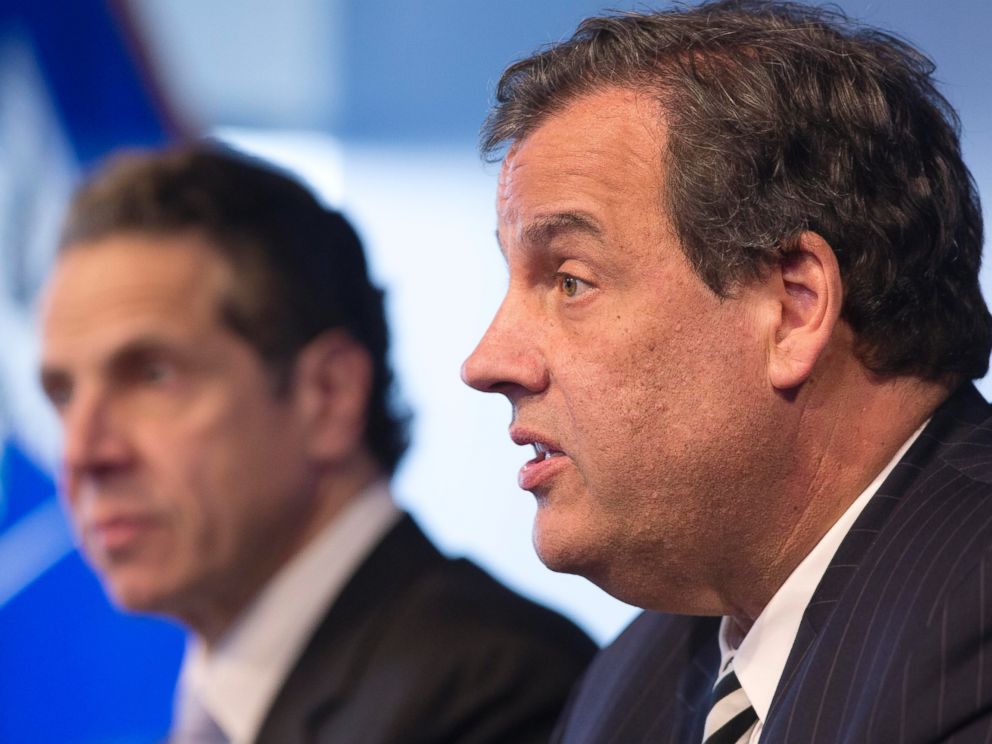 New York Governor Andrew Cuomo, left, listens as New Jersey Governor Chris Christie talks at a news conference, Oct. 24, 2014 in New York.