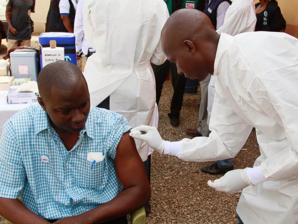 PHOTO:A health worker, right, cleans a mans arm before injecting him with a Ebola vaccine in Conakry, Guinea in this March 7, 2015 file photo.