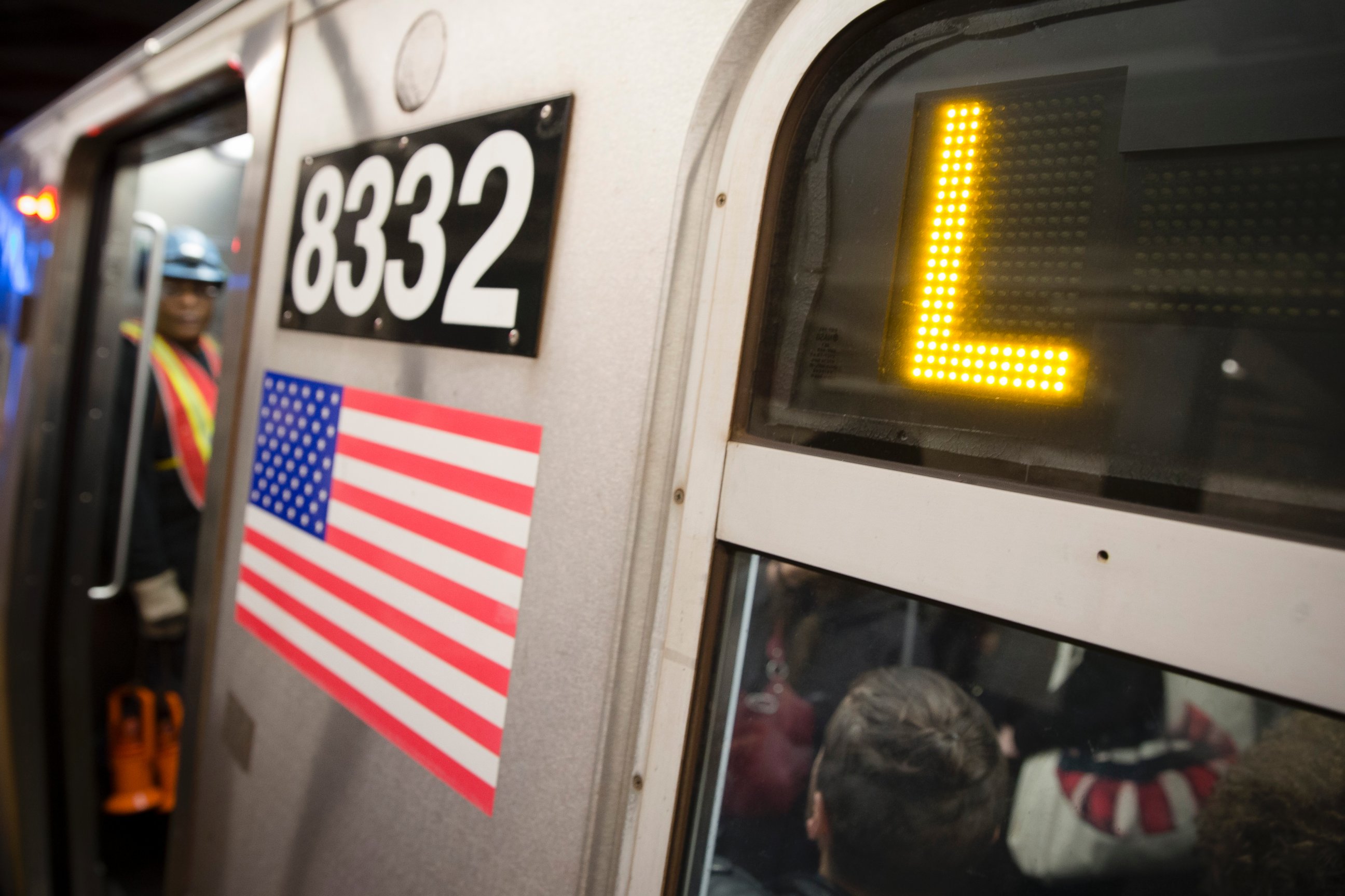 Riders stand inside an L-Train subway car, Thursday, Oct. 23, 2014, in New York.