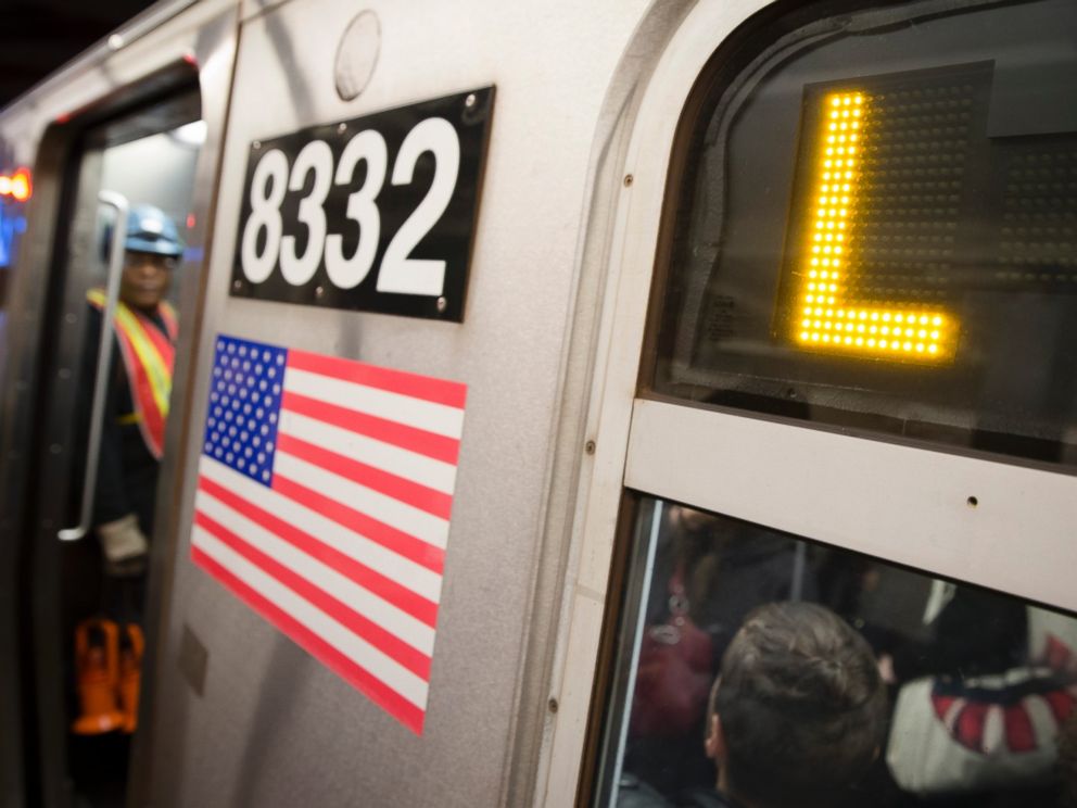 Riders stand inside an L-Train subway car, Thursday, Oct. 23, 2014, in New York.
