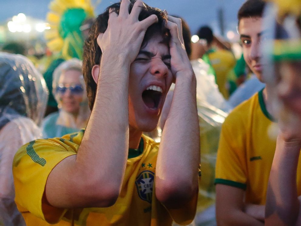 PHOTO: A Brazil soccer fan reacts in frustration as he watches his team play a World Cup semifinal match against Germany on a live telecast inside the FIFA Fan Fest area on Copacabana beach in Rio de Janeiro, Brazil on July 8, 2014. 