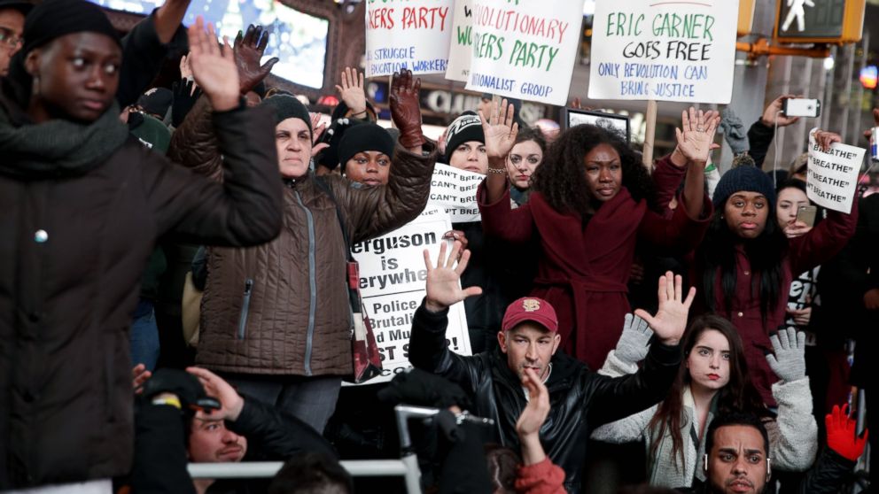People participate in a protest in response to the grand jury's decision in the Eric Garner case in Times Square in New York, Dec. 3, 2014.