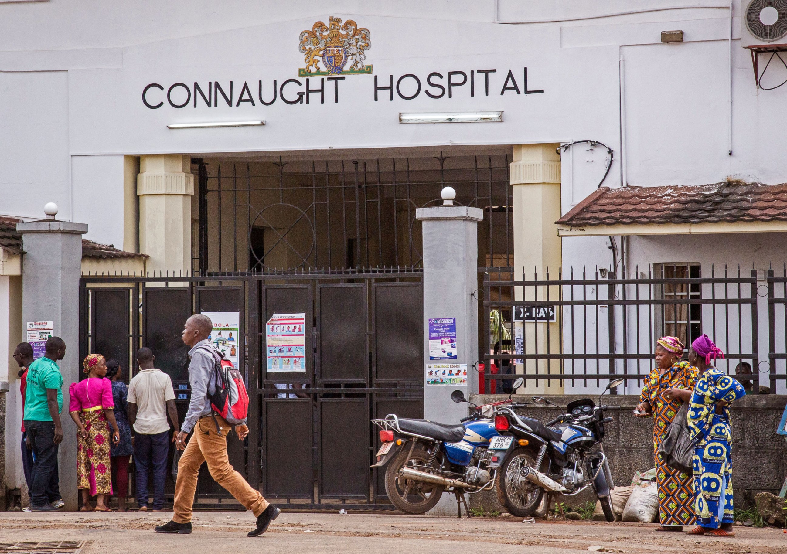 PHOTO: People walk past the Connaught Hospital that is used for treatment of Ebola virus victims in the city of Freetown, Sierra Leone on Aug. 6, 2014. 