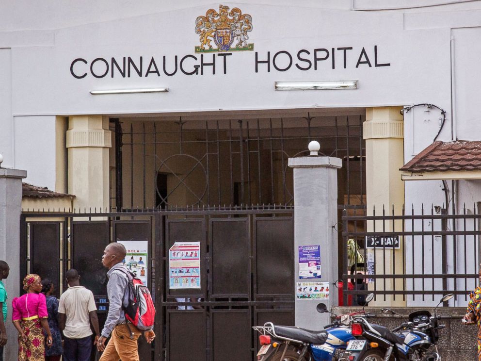 PHOTO: People walk past the Connaught Hospital that is used for treatment of Ebola virus victims in the city of Freetown, Sierra Leone on Aug. 6, 2014.
