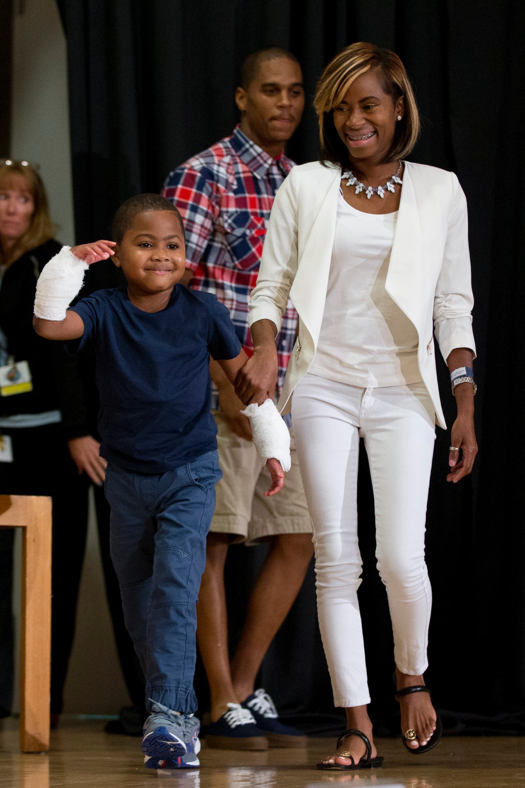PHOTO: Double-hand transplant recipient, eight-year-old Zion Harvey, arrives to a news conference with his mother Pattie Ray on July 28, 2015 in Philadelphia. 