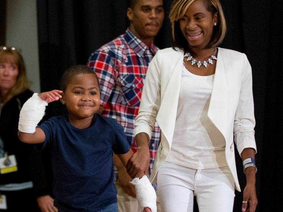 PHOTO: Double-hand transplant recipient, eight-year-old Zion Harvey, arrives to a news conference with his mother Pattie Ray on July 28, 2015 in Philadelphia.
