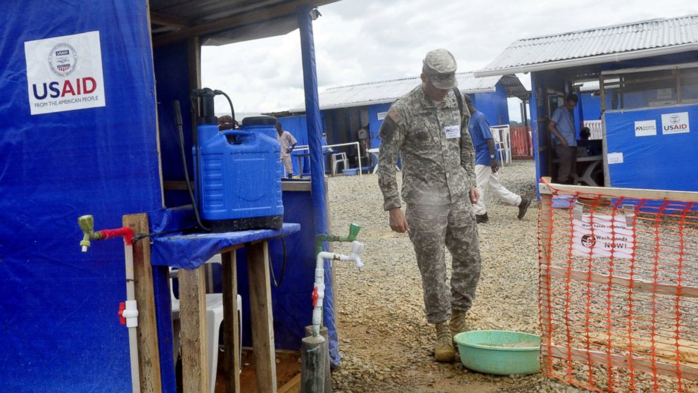 A member of the U.S army walks past a newly constructed Ebola treatment centre in Bongcounty, on the outskirts of Monrovia, Liberia, Oct. 7, 2014. 