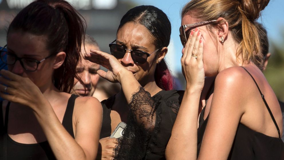 Women react near the scene of an attack where a truck mowed through revelers in Nice, southern France, July 15, 2016. 