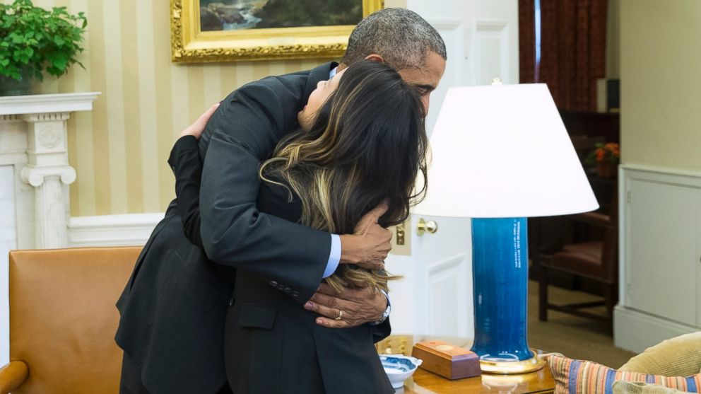 President Barack Obama hugs Ebola survivor Nina Pham in the Oval Office of the White House in Washington, D.C. on Oct. 24, 2014. 