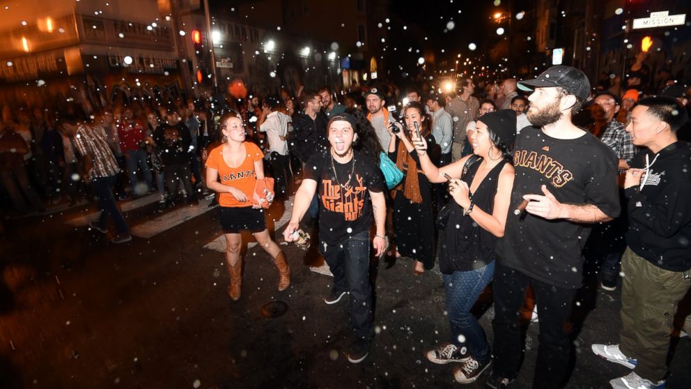 PHOTO: San Francisco Giants fans celebrate in the Mission district after the San Francisco Giants beat the Kansas City Royals to win the World Series on Oct. 29, 2014, in San Francisco. 