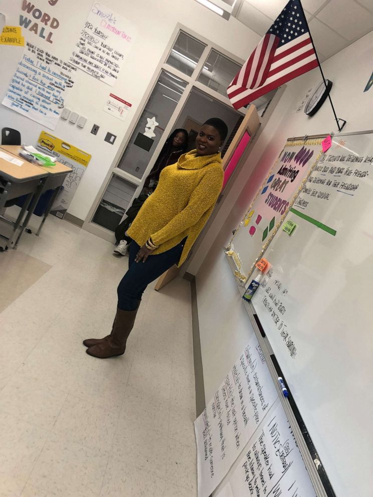 PHOTO: Chimére Smith poses in her classroom at the school where she was a teacher in 2017. Her long COVID symptoms have left her unable to work.