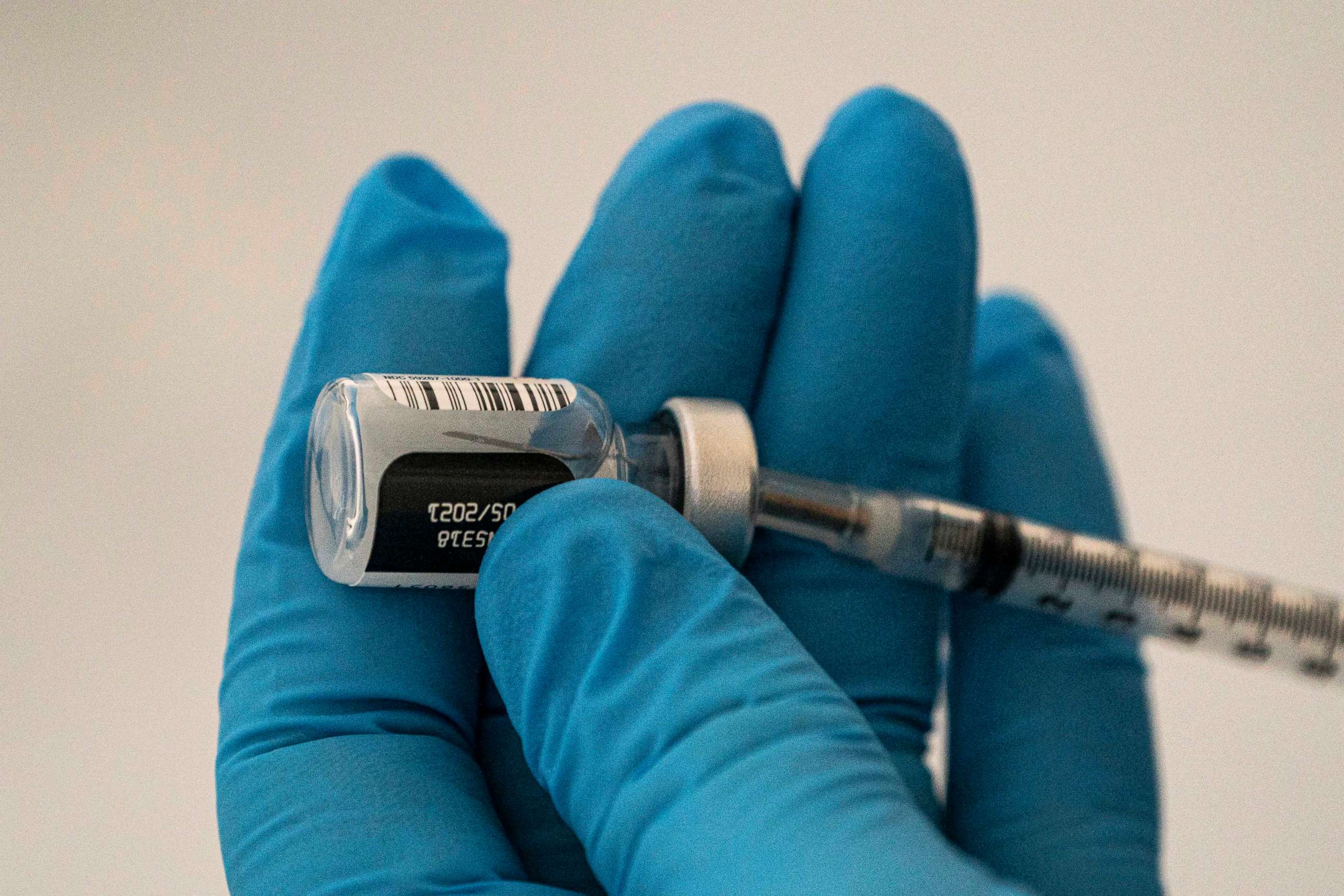 PHOTO: WENATCHEE, WA - JANUARY 26: A pharmacist prepares COVID-19 vaccines for patients arriving at Town Toyota Center on January 26, 2021 in Wenatchee, Washington. 