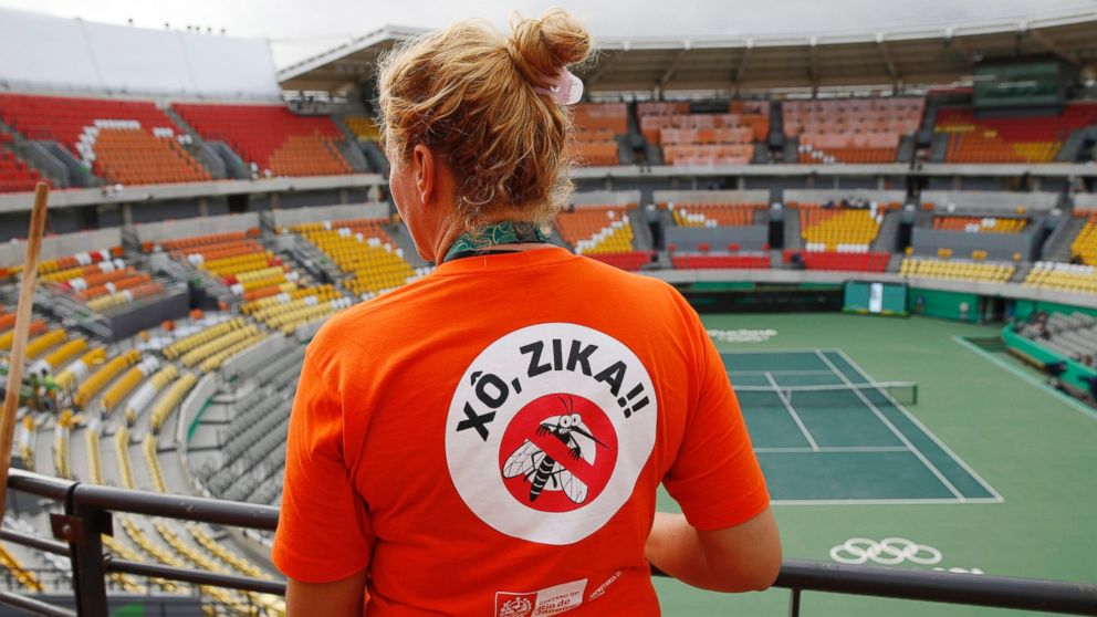 A worker cleaning at the Olympic Tennis Center wears a shirt with an anti-Zika slogan in Rio de Janeiro, Brazil, Aug. 3, 2016.