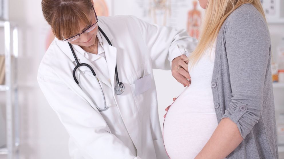 Pregnant woman talking with her doctor in this undated photo.
