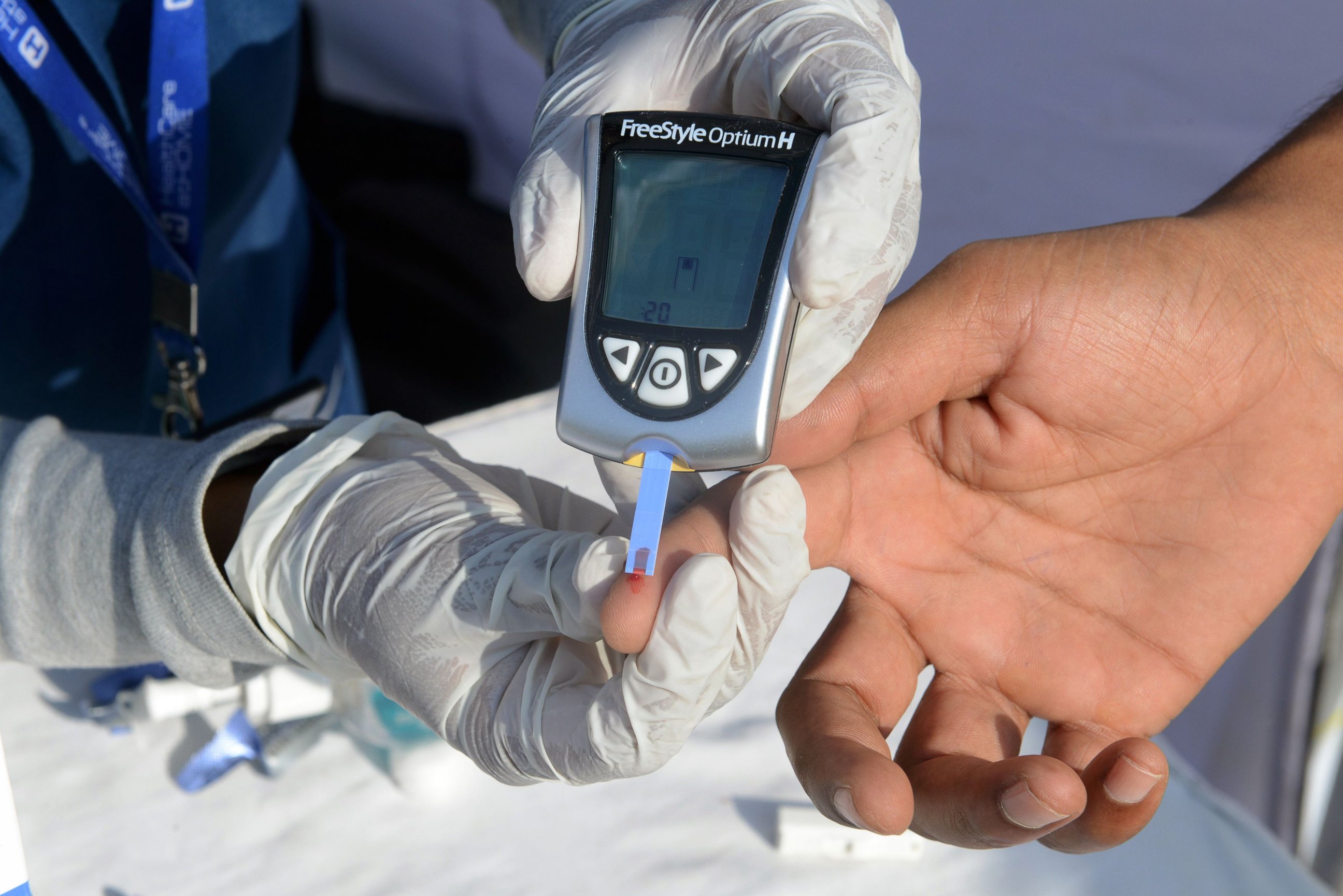 PHOTO: A nurse collects a blood sample from a policeman using a glucometer at a free diabetic health check-up camp on World Health Day in Hyderabad, India on April 7, 2016.  "Beat Diabetes" is the theme of World Health Day 2016.