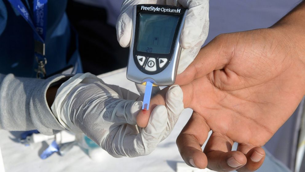PHOTO: A nurse collects a blood sample from a policeman using a glucometer at a free diabetic health check-up camp on World Health Day in Hyderabad, India on April 7, 2016.  "Beat Diabetes" is the theme of World Health Day 2016.