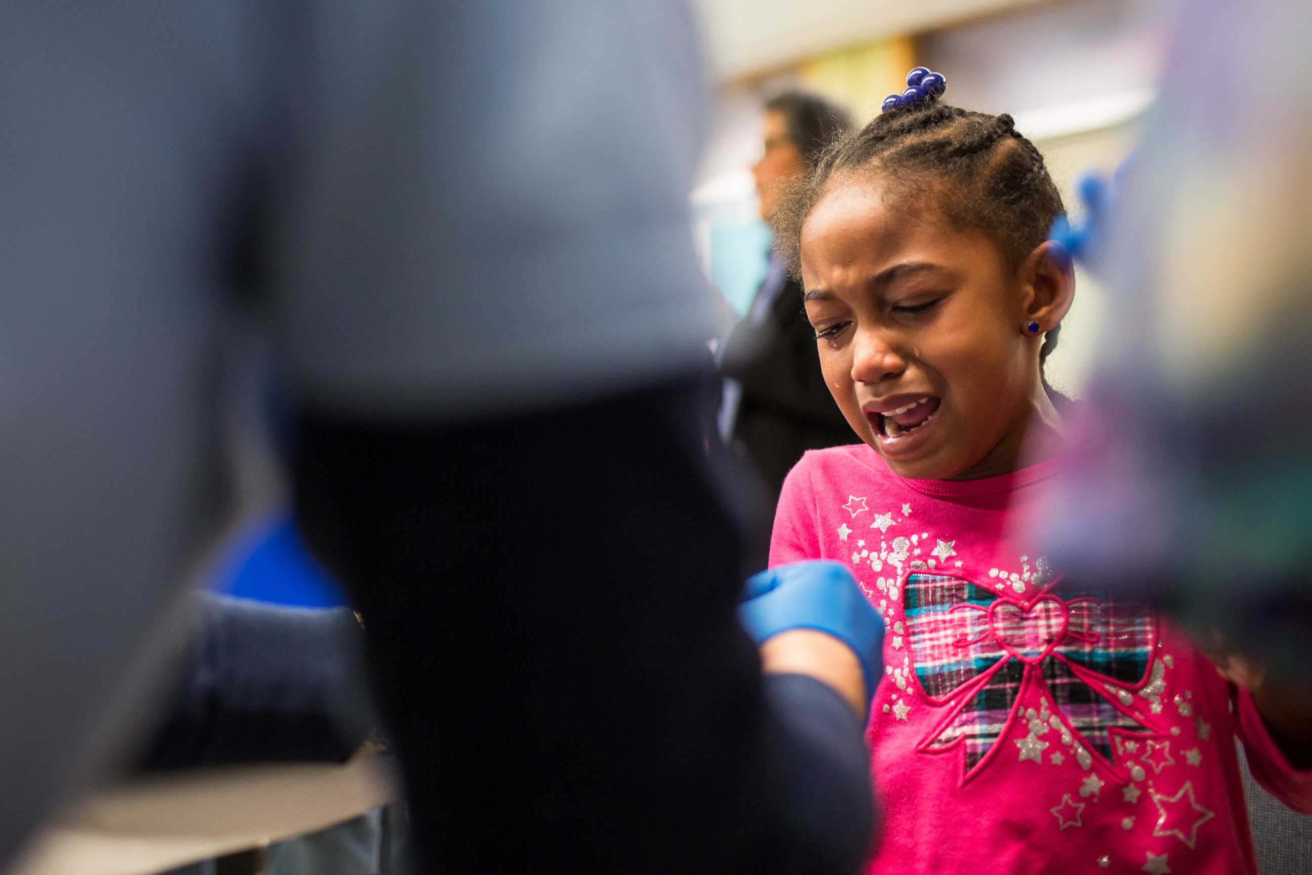 PHOTO: Tears stream down the face of Morgan Walker, age 5 of Flint, as she gets her finger pricked for a lead screening on Jan. 26, 2016 at Eisenhower Elementary School in Flint, Mich.  