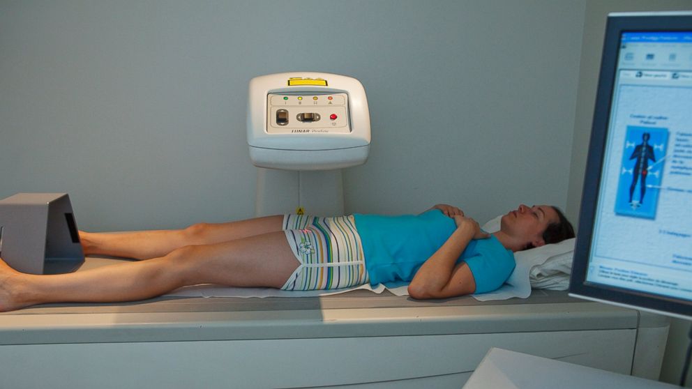 Female patient undergoing a bone densitometry examination.